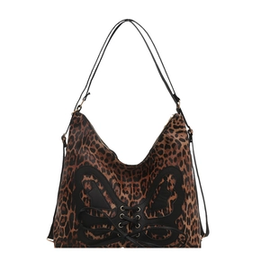 Leopard print tote bag with butterfly leather corset detail on a white background