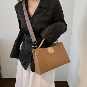 Brown PU leather bag featuring geometric embossing and a colorful tribal wide strap