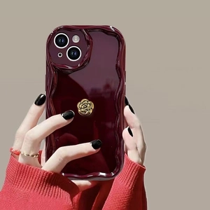 Burgundy wave edge case for iPhone featuring a 3D golden rose flower decoration