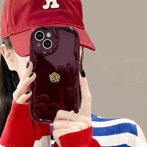 Luxury wine red iPhone case with wavy edges and a 3D gold rose flower ornament