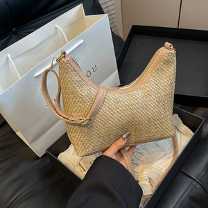 Women's woven crescent tote bag with faux leather trim for beach and travel