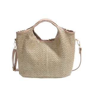 Chic woven straw tote bag in light khaki with brown handles for beach travel and vacations