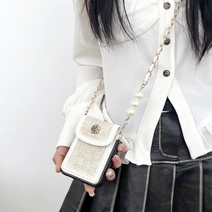 Detail of tweed crossbody phone case with camellia metal clasp and pearl chain