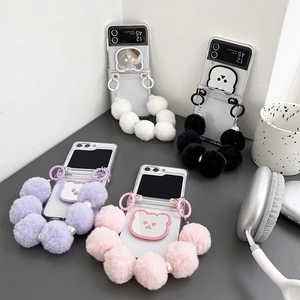 Detailed view of clear folding phone cases with plush bear mirrors and pearl handles