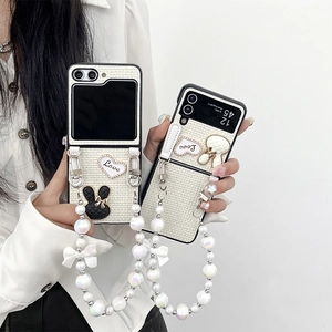 Chic Samsung Galaxy Z Flip protective case with woven texture, bunny charm, and pearl strap