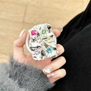 Macro view of silver metallic pleated phone grip with colorful baguette rhinestones