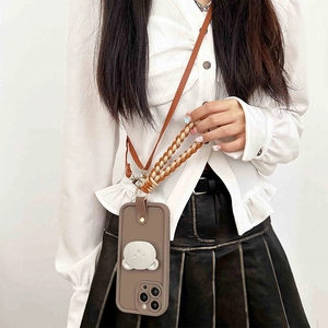 Brown leather phone case with bear stand and woven strap shown on a model