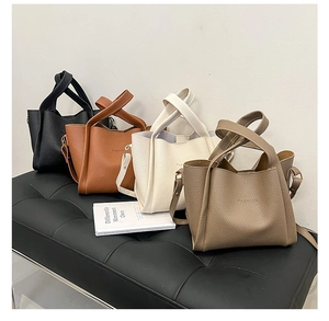 Detailed view of four fashion tote bags in lychee grain leather with FASHION logo
