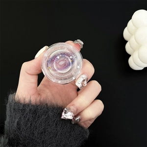 Detail of transparent planet phone grip with purple nebula and glitter in hand