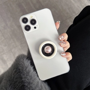 Minimalist white phone case with a round pink pearlescent expandable socket grip