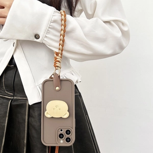 Taupe iPhone case with golden bear stand and woven crossbody strap shown on a model