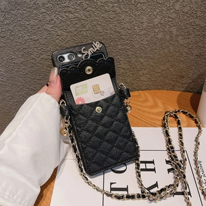 Quilted black leather phone wallet case with gold chain strap and Smile ornament