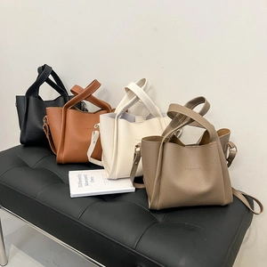 Litchi pattern bucket bags in black, brown, cream, and taupe with wide handles
