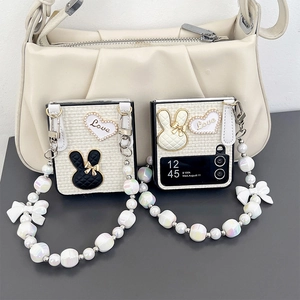 Detail of Galaxy Z Flip case featuring quilted rabbit patches and colorful pearl strap