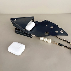 Detail of triangular black leather earphone pouch with pearls and gold chain strap