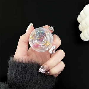 Macro shot of transparent planet resin phone grip with glitter and star orbital details