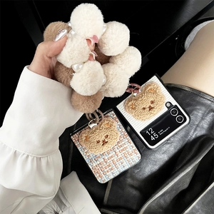 Detail of Galaxy Z Flip case with plush bear patch and faux pearl wrist strap lanyard