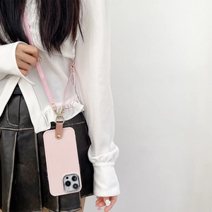 Pink silicone iPhone case with adjustable leather crossbody strap worn by a model