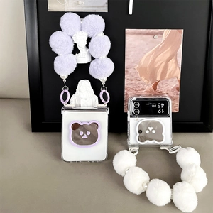 Detailed view of clear folding case with plush ball lanyard and bear mirror for Z Flip6