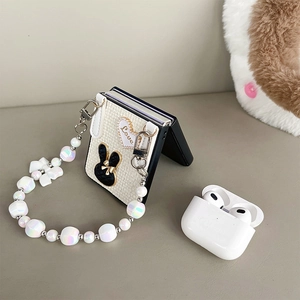 Detailed knit texture phone case with bunny charm and pearly bead wrist strap charm