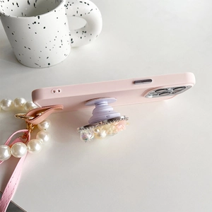 Pink matte phone case featuring flower rhinestone grip and elegant pearl shoulder strap