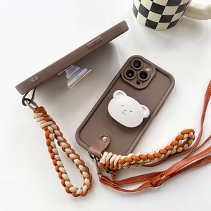 Detail of iPhone case with 3D bear grip, woven hand strap and crossbody lanyard