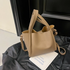 Chic light brown lychee grain bucket bag with wide top handle and detachable strap