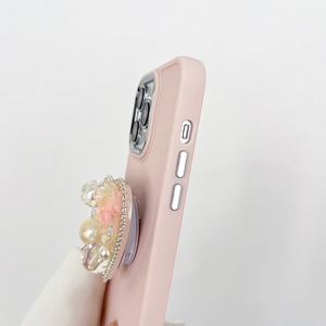Detail of pink silicone iPhone case featuring 3D floral stand with pearls and rhinestones