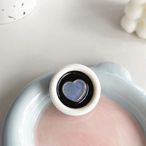Macro shot of circular phone socket with shimmering blue heart and white outer ring