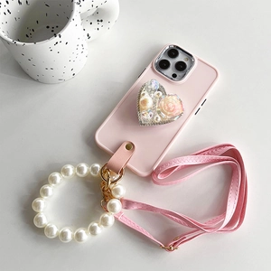 Pink iPhone case detail with heart stand, pearl strap and crossbody chain