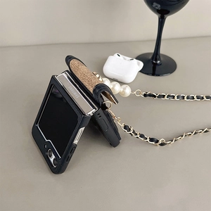 Detail of Samsung Z Flip case with leather camellia texture and pearl crossbody chain strap
