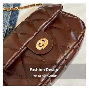 Detailed macro view of deep brown quilted faux leather texture with golden metal twist lock