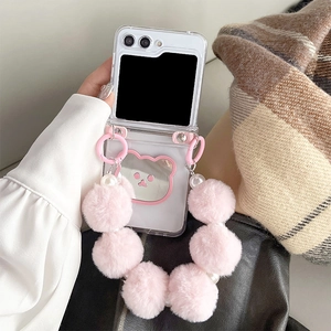 Detail of transparent folding case with pink bear mirror and plush bead lanyard
