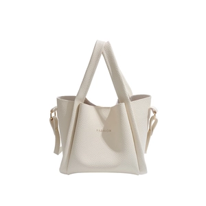 Modern off-white leather bucket bag with geometric folds and golden fashion text