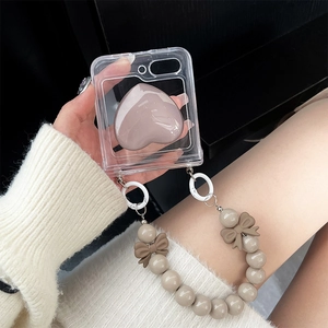 Detail of transparent Z Flip 6 case with pink 3D heart and beaded bow hand strap