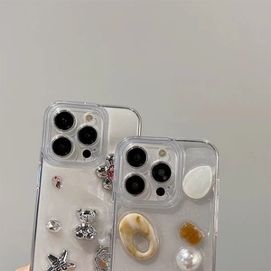 Close-up of glitter iPhone cases with 3D silver bear, pearl flowers and star charms