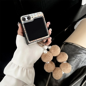 Detail of tweed Samsung Galaxy Z Flip case with plush bear and pearl wrist strap
