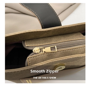 Detailed macro view of gold metal zipper and magnetic closure on textured bucket bag