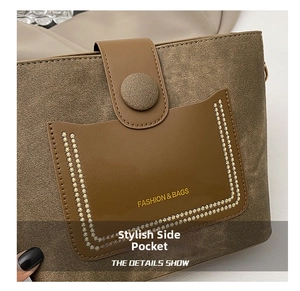 Detail of tan fabric bucket bag showing brown leather pocket with FASHION & BAGS embroidery