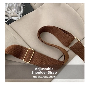 Detail of adjustable brown woven shoulder strap with premium gold metal buckles