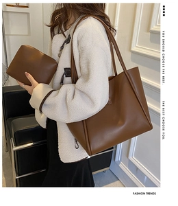 Close-up of brown faux leather tote bag set with a matching small zipper pouch