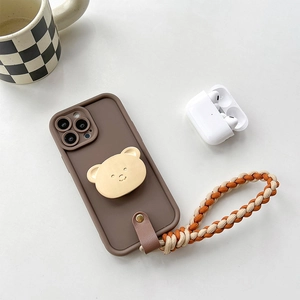 Brown matte phone case with bear grip and woven crossbody strap on white background