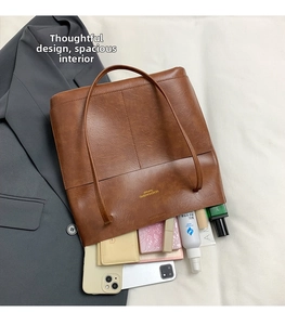 Spacious interior of brown PU leather tote bag filled with daily essentials and makeup