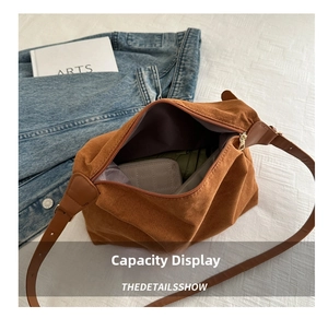 Detail view of large brown faux suede shoulder bag with spacious interior and inner lining