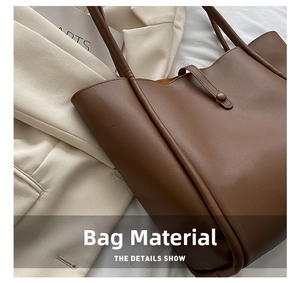 Detailed macro view of the matte brown faux leather texture on the stylish tote handbag