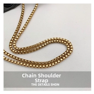 Macro detail of high-quality gold box chain shoulder strap with metallic finish
