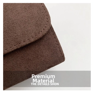Detailed macro view of dark coffee brown suede texture with fine reinforced stitching