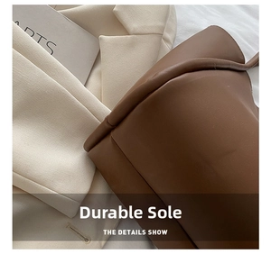 Detail shot of durable reinforced bottom and fine stitching on dark brown leather tote bag