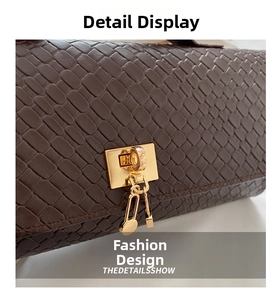 Macro detail of brown leather woven bag with golden padlock and key charm