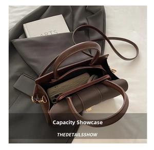 Interior view showing the large capacity and middle zipper pocket of the dark brown leather tote